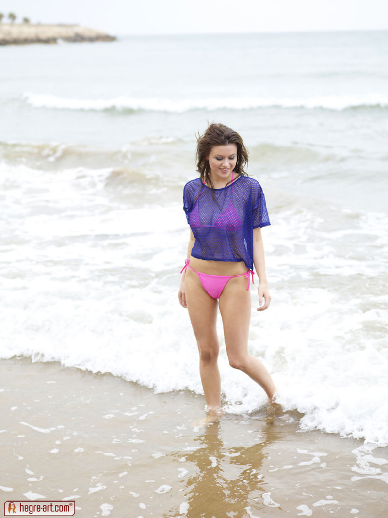 Brunette with big naturals posing at the beach-01